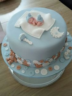 a baby is sleeping on top of a blue cake with white and brown trims