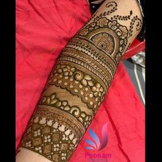 a woman's arm with henna tattoos on it