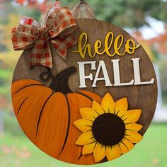 a wooden sign that says hello fall with a sunflower on it and a bow