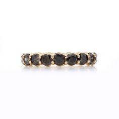 a gold ring with black diamonds