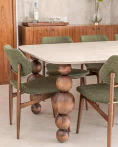 a white table with green chairs around it