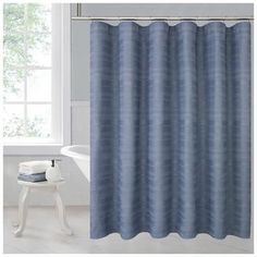 a blue shower curtain next to a white bath tub