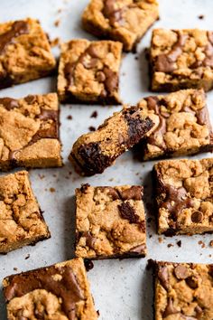 chocolate chip cookie bars cut into squares on a baking sheet, ready to be eaten