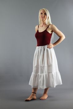 White Slimline Cotton Petticoat (50% cotton, 50% polyester) Slimmer top section than most of our other Petticoats - Gathered onto a narrow elastic  Waist made to order - please choose waist size from options - if you require a larger waist please request a custom order Delicate Broderie Anglaise part way down (this can be excluded just select 'No' in options) Ruffled Bottom section with a Beautiful Guipure Lace Edge Finally choose your exact length - see options Once all confirmed we will make up your Petticoat to your exact size White Sleeveless Petticoat For Summer, White Cotton Petticoat With Attached Cancan, White Cotton Skirt With Attached Cancan, White Cotton Lined Petticoat, White Lined Cotton Petticoat, White Cotton Petticoat With Lace Trim, White Cotton Summer Petticoat, Fitted Cotton Petticoat With Tiered Skirt, Summer White Cotton Petticoat