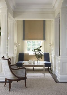 a living room filled with furniture and white walls