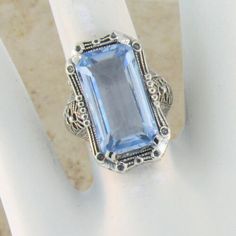 Vintage Estate 8 Carat Simulated Aquamarine Filigree Ring. Floral Details. 925 Solid Sterling Silver. Stamped 925. Excellent Condition. Like New. Classic Silver Rectangular Sapphire Ring, Heirloom Style Silver Sapphire Ring, Elegant Silver Engraved Ring With Gemstone, Heirloom Silver Sapphire Ring, Victorian Sapphire Ring With Center Stone In Silver, Silver Victorian Sapphire Ring For Gift, Art Deco Silver Sapphire Ring For Anniversary, Victorian Style Silver Sapphire Ring As Gift, Victorian Style Silver Sapphire Ring Gift