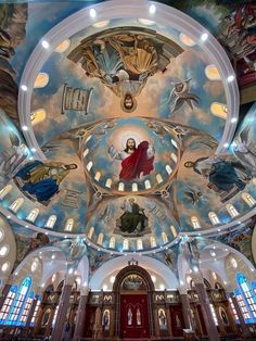 the inside of a church with paintings on the ceiling