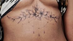 a close up of a woman's stomach with flowers on it