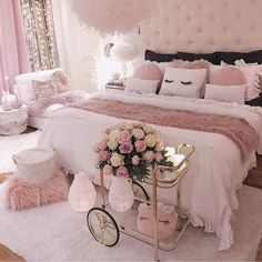 a bedroom decorated in pink, white and gold with a bicycle on the floor next to it