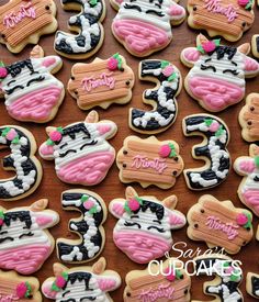 decorated cookies are arranged on a wooden table