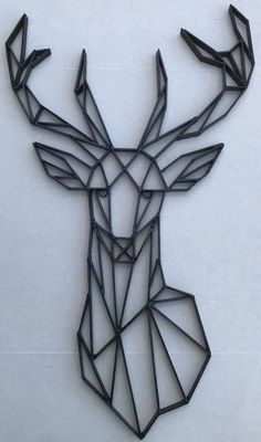 a metal deer head with geometric shapes on it's antlers, against a white background