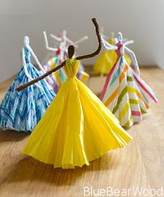 four paper umbrellas sitting on top of a wooden table