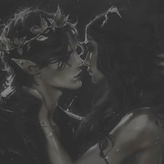 two women are kissing in the dark with leaves on their head and one is wearing a tiara