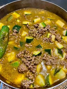 a pot filled with meat and vegetables on top of a table