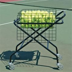 tennis balls in a cart on the court