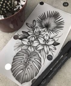 a black and white drawing of flowers on a cutting board next to a potted plant