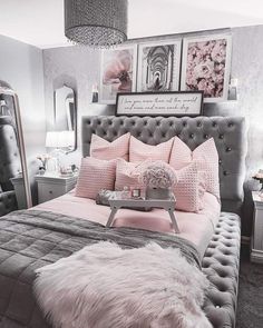 a bedroom with pink and grey decor in the corner, including a tufted bed