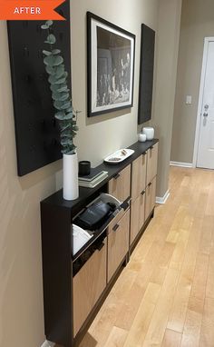 a living room with wood flooring and an art piece on the wall above it