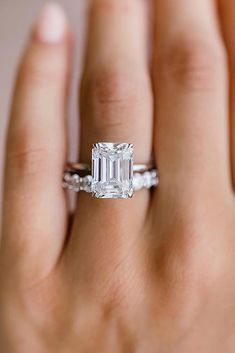 a woman's hand with a diamond ring on it