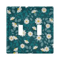 a light switch cover with daisies and leaves on blue background, in the shape of a flower