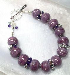 Purple Rain in a Lampwork Beaded Bracelet by Alliaks on Etsy, $85.00 Elegant Beaded Crystal Bracelet For Birthday, Czech Glass Beaded Jewelry Gift, Purple Rondelle Beaded Bracelets As Gift, Rondelle Beaded Bracelet With Large Beads As Gift, Handmade Purple Sterling Silver Beaded Bracelets, Handmade Crystal Bracelet With Round Beads For Gift, Handmade Crystal Bracelet With Round Beads As Gift, Handmade Spiritual Beaded Bracelets For Wedding, Round Beaded Bracelets With Silver Beads As Gift