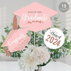 graduation decorations with flowers in a vase and congratulations stickers on the top of each one