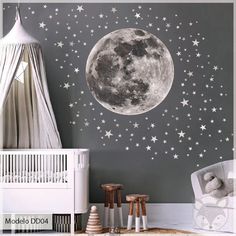 a baby's room with stars and moon decals on the wall