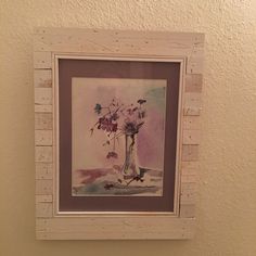 a painting hanging on the wall next to a toilet