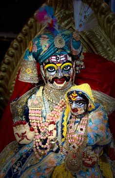 two people dressed in colorful costumes and makeup