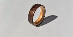 a wooden ring sitting on top of a white surface