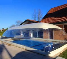 an inflatable swimming pool on the side of a house with a tiled roof