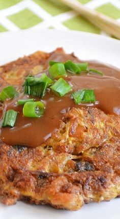 a close up of a plate of food with gravy and vegetables on it