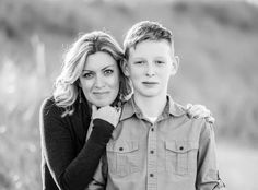 black and white photo of two people posing for the camera with their arms around each other