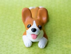 a small toy dog sitting on top of a green table