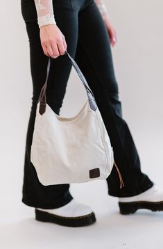 Our Anniston hobo bag is as cute as it is functional. It comes with two magnetic-snap compartments on top of each side of the main zipper-enclosed compartment. This makes it a breeze to throw in your phone or keys that you might need quick and easy access to, while still being able to zip up your wallet or cash in a more concealed and safe compartment. You're going to love the size of this bag too. it's big enough to store your necessities, but you'll never feel like you're carrying around a bul Casual Bags With Zipper Pocket For Everyday Use, Functional Everyday Tote Hobo Bag, Everyday Beige Shoulder Bag With Cell Phone Pocket, Functional Crossbody Hobo Bag For Everyday, Versatile Beige Hobo Bag For Everyday Use, Casual Hobo Bag With Double Handle For On-the-go, Versatile Everyday Canvas Softback Bag, Versatile Canvas Bag With Zipper Closure, Versatile Canvas Shoulder Bag For Everyday