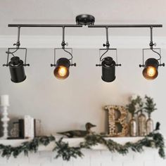 three lights hanging from the ceiling above a fireplace