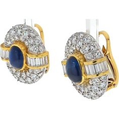 Traverse the landscape of refined aesthetics with the Van Cleef & Arpels 18K Yellow Gold Sapphire And Diamond Clip On Earrings, a masterpiece of timeless allure. These earrings embody sophistication with a captivating oval cabochon-cut sapphire, measuring 9mm long, exuding a deep, velvety blue hue that draws the eye and ignites the imagination. The sapphire is embraced by pave-set round diamonds, their brilliance delicately enhancing the allure of the central gemstone and infusing the earrings with a mesmerizing sparkle.Adding to the geometric elegance are straight baguette-cut diamonds strategically placed to create a sense of precise symmetry and luxury. With a length of 22mm, these earrings command attention and make a bold statement of refined taste and opulence. Crafted from 18K yello Luxury Hallmarked Fine Jewelry Clip-on Earrings, Luxury Oval Clip-on Earrings For Women, Luxury Clip-on Oval Cabochon Earrings, Luxury Oval Cabochon Clip-on Earrings, Diamond Birthstone, Gold Clips, Baguette Cut Diamond, Van Cleef Arpels, Baguette Cut