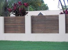 a white fence with wooden slats on it