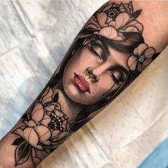 a woman's face with flowers on her arm