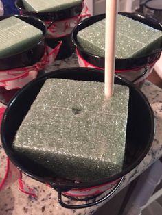 four pans filled with green food sitting on top of a counter next to each other