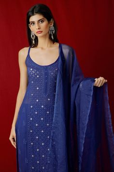 Blue chikankari kurta with mukaish work and straight silhouette. Comes with straight pants and dupatta.
Component: 3
Pattern: Embroidery
Type Of Work: Resham Embroidery and Mukaish
Neckline: Round
Sleeve Type: Sleeveless
Fabric: Georgette
Color: Blue
Other Details: 
Side slits
Shoulder straps
Mukaish work on dupatta
Bead detail on the placket
Occasion: Destination Wedding - Aza Fashions Traditional Sleeveless Blue Kurta, Blue Sleeveless Chikankari Embroidery Set, Blue Sleeveless Set With Chikankari Embroidery, Blue Sleeveless Sets With Chikankari Embroidery, Blue Sleeveless Traditional Wear, Traditional Blue Sleeveless Anarkali Set, Blue Chikankari Kurta, Work On Dupatta, Chikankari Kurti Set