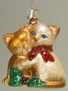 an ornament shaped like a cat and kitten hugging