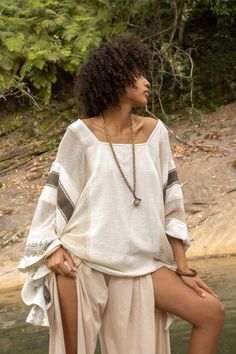 Introducing the TAIKI Light Poncho Top, a one-of-a-kind garment that seamlessly blends the best of ponchos and kaftans for a unique, versatile style statement. Crafted from 100% natural cotton that rests beautifully on your exposed collar bones, the TAIKI Light Poncho Top features a free-flowing, butterfly-style cut that drapes elegantly around the body, creating a flattering silhouette that works for any occasion. The semi-see-through netted fabric in some sections adds an alluring touch of tex Bohemian Blouse With Kimono Sleeves, Oversized Bohemian Tunic Blouse, Oversized Bohemian Tunic Tops, Bohemian Oversized Tunic Tops, Bohemian Beige Kaftan For Beach Cover-up, Beige Long Sleeve Kaftan For Beach Cover-up, Bohemian Beige Blouse For Vacation, Bohemian Blouse With Kimono Sleeves For Beach, Bohemian Batwing Sleeve Blouse For The Beach