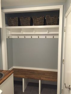 a white closet with shelves and baskets on it