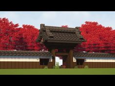 a japanese style building with red trees in the background