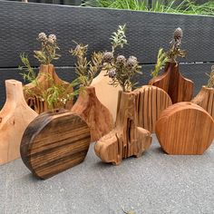 several wooden vases with plants in them