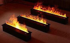 three black boxes with flames in them on the floor