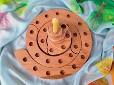 a wooden spinning wheel with a candle on it