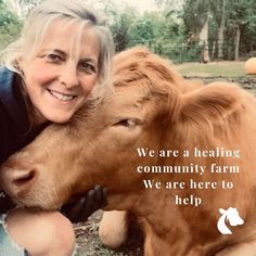 a woman is petting a brown cow on the head and smiling at the camera