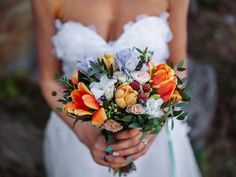 a woman holding a bouquet of flowers in her hands